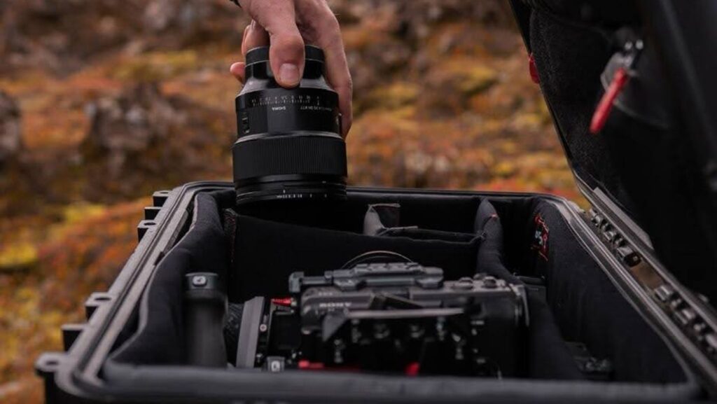 Hand placing camera lens into case.
