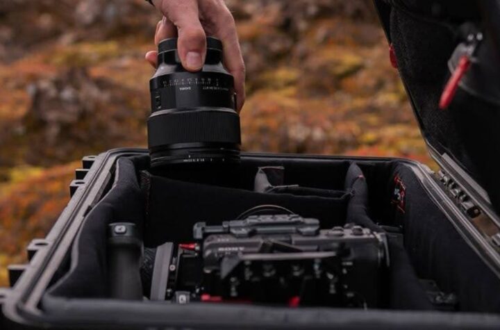 Hand placing camera lens into case.