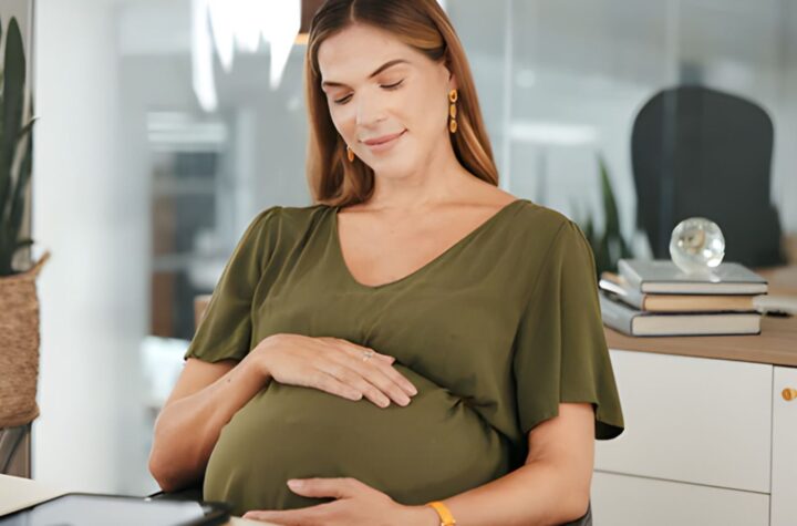 Pregnant woman in office.