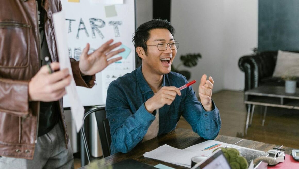 Laughing teammate during casual office meeting.