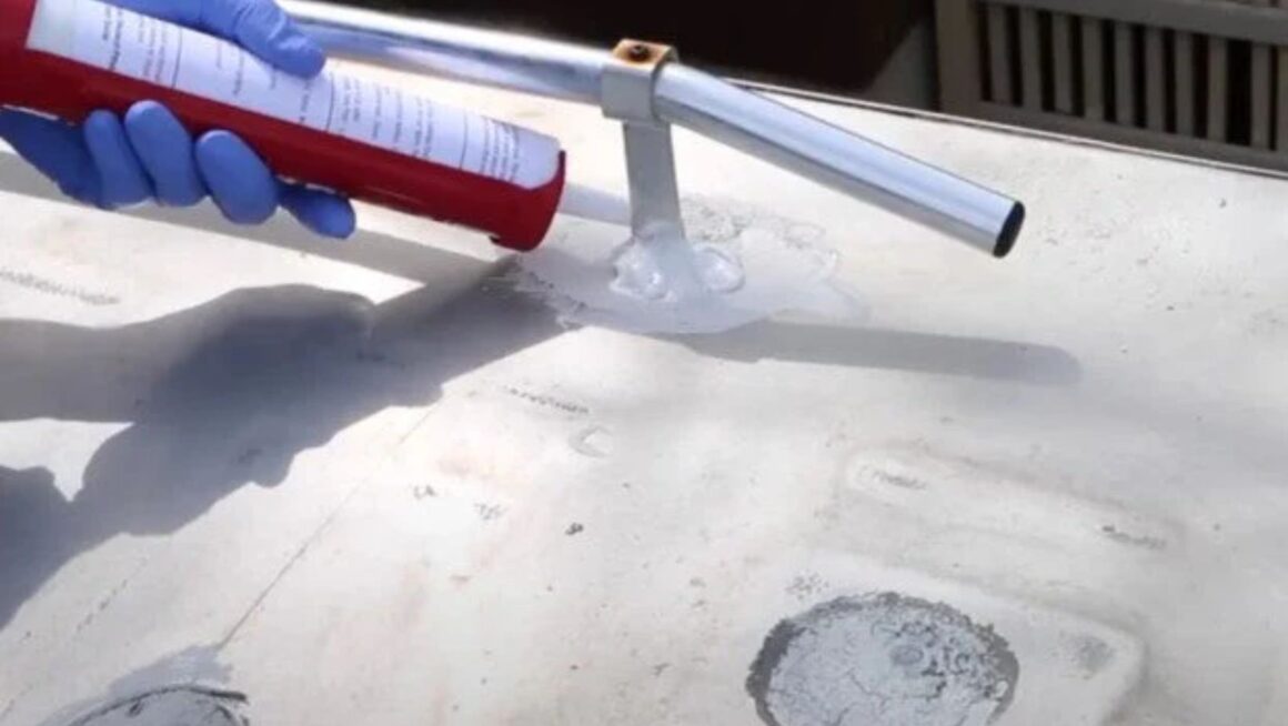 Applying sealant to roof rack mount.
