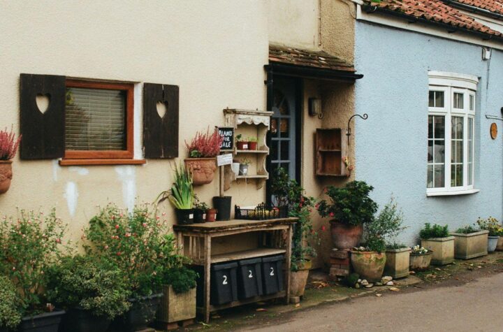 A row of terraced homes with tidy front gardens on a quiet residential street.